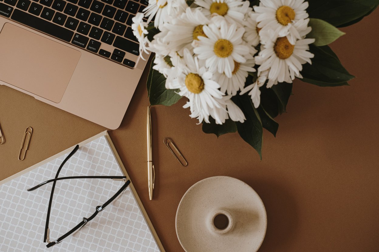 Office Desk with Laptop and Bouquet of Flowers